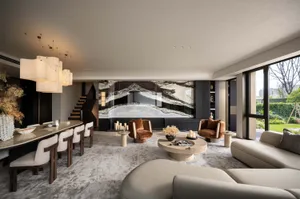 Modern living room featuring marble accents, plush leather chairs, and a wooden coffee table.