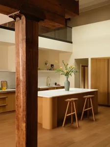 Modern residential kitchen featuring a marble countertop and wooden cabinets.