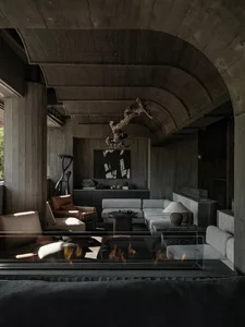 A living room with industrial design features, concrete materials, and minimalist furniture.