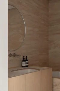 Modern bathroom featuring a sink with concrete walls and minimalist design.