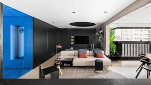 Modern living room with concrete walls, tiled accent wall, and leather upholstered furniture.