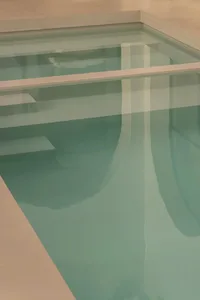 A serene reflection of a minimalist poolside setting.