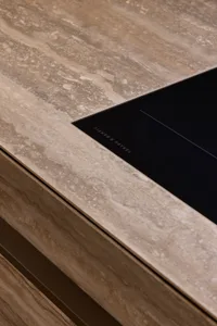 Modern kitchen with terrazzo countertop and sleek black stove top.