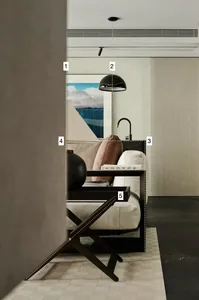 Modern living room with a white sofa, wooden accents, and a black lamp.