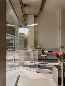 Modern lobby featuring glass walls and concrete elements