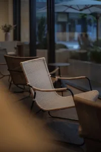 A cozy interior space featuring woven fabric chairs and a serene atmosphere.