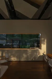 A modern café interior with wooden furnishings and a large window
