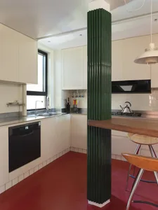 A modern kitchen featuring white cabinets and appliances.
