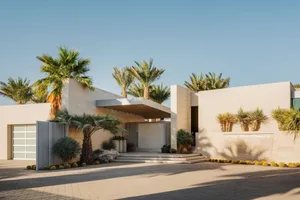 Modern home entrance featuring concrete and glass materials.