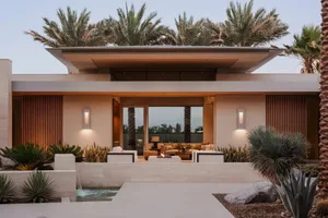 Modern residential architecture featuring concrete, wood, and glass materials.