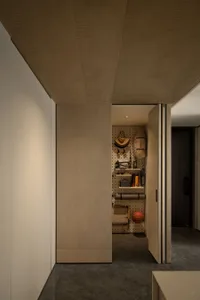 A minimalist closet with wooden walls and a pegboard for organizing items.