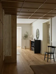 Minimalist living room with wood flooring and black chair