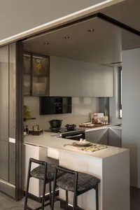 A modern, minimalist kitchen featuring marble countertops and sleek, contemporary cabinetry.