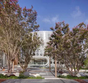 Modern office space featuring metallic glass walls and circular windows.