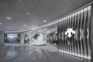 Modern storefront with metallic display case, glass windows, and concrete floor.