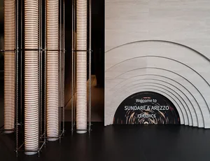 Modern architectural design featuring illuminated ceramic columns in an exhibition setting.