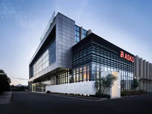 A modern office building with glass and concrete exterior features a sleek, minimalist design.