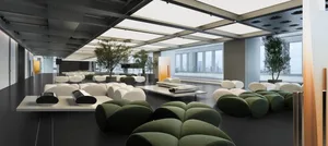 Industrial-style office lounge featuring fabric seating, concrete flooring, and modern metal accents.