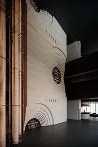 Modern minimalist lobby with white marble walls and columns.
