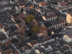 Aerial view of an ancient town with residential houses featuring concrete and wooden structures.