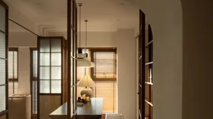 A modern office space featuring wooden blinds and clean lines.
