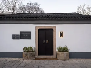 A traditional entrance with brick and concrete materials.
