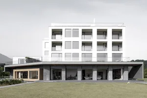 Modern apartment building with glass and concrete exteriors and large windows.