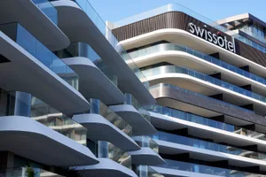 Swissotel hotel with modern glass and concrete design features.