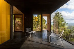 A modern, industrial-style patio with metal and wooden furniture.