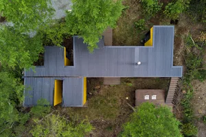 A modern architectural extension with a metallic roof.