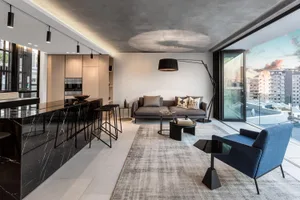 A modern residential living room featuring a concrete floor and marble accents.