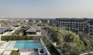 A view of a cityscape featuring modern residential buildings with concrete, glass, and brick exteriors.