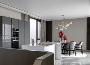 A modern kitchen featuring metallic materials and a marble countertop.