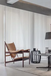 Modern living room with leather furniture, wooden accents, and metallic elements
