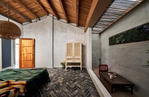 An industrial-style bedroom featuring wooden furniture.