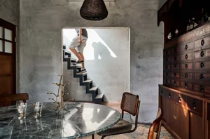 Minimalist interior design featuring a concrete staircase and modern furnishings.