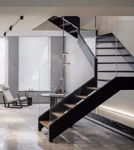 Industrial-style living room featuring modern metal staircase, glass wall, and marble flooring