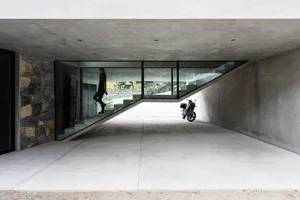 Concrete, minimalist interior space with a modern aesthetic.