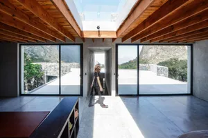 A modern interior design with a minimalist aesthetic featuring concrete and stone materials.