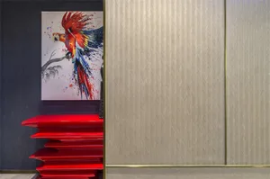 An abstract painting of a parrot perched on a red shelf.