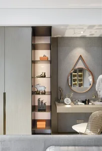 Modern dresser space featuring metallic shelves and a circular mirror.