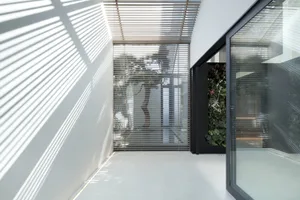 Modern industrial interior design featuring metal, glass, and concrete materials.