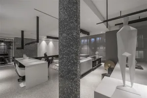 A modern living room with concrete walls and a minimalist design.