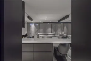 Modern living room with glass cabinets, concrete walls, and minimalist furniture.
