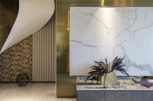 Modern living room featuring marble walls, metallic accents, and wooden elements.