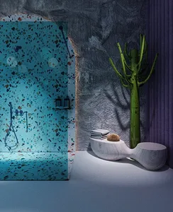 Modern minimalist bathroom with blue terrazzo tiles in a cave-like setting.