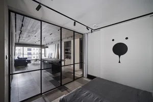 Modern bedroom with concrete floor and minimalist design.