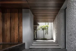 A modern interior design featuring concrete and wooden elements.