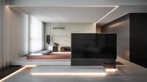 An image of a modern living room featuring a concrete floor and minimalist decor.