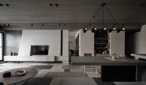 Contemporary minimalist living and dining area with concrete walls and flooring.